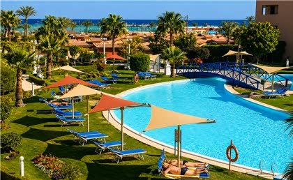 Shade sails and loungers beside the pool at Titanic Beach Resort